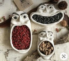 three ceramic bowls filled with nuts and beans