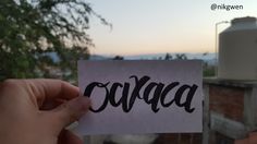 someone holding up a piece of paper with the word cova written in black ink