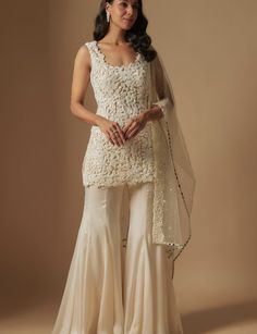 White Fitted Sharara For Traditional Ceremonies, Fitted White Sharara For Festive Occasions, Elegant Cream Sharara For Party, Fitted White Sharara For Party Wear, Bollywood Style Beige Sharara For Festive Occasions, Bollywood Style Cream Sharara For Party, Cream Sharara With Dupatta For Party, White Bollywood Style Sharara For Party, Bollywood Style White Sharara For Party