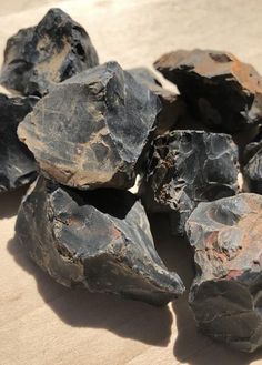 some black rocks sitting on top of a wooden table