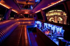 the inside of a limo with blue lights and decorations on it's side wall