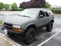 a gray suv parked in a parking lot