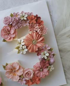 the letter e is made out of paper flowers