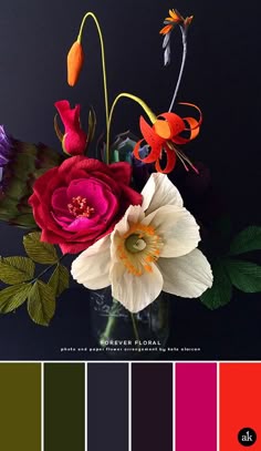 a vase filled with flowers on top of a black table next to color swatches