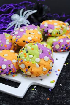 halloween cookies with sprinkles on a white plate