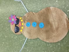 a child's craft made to look like a caterpillar on the ground