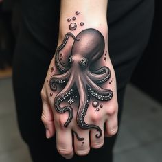 a hand with an octopus tattoo on it