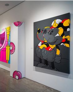 paintings on the wall in an art gallery