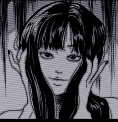 a woman with long hair and bangs standing in front of a window holding her hand up to her face