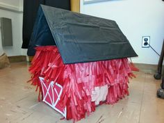 a house made out of red and black tissue paper