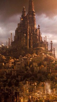 a very tall castle sitting on top of a lush green hillside under a cloudy sky