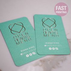 two green business cards with the words open hearts menu printed on them, sitting next to each other