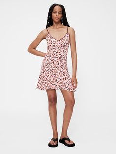 Soft rayon-viscose blend crepe mini dress.  V-neck.  Adjustable spaghetti straps.  Empire waist.  Zipper at back.  Allover abstract print.  Made with 50% LENZING™ ECOVERO™ viscose fibers, which are derived from controlled or certified wood sources.  Fit: Slim.  A fit & flare silhouette that sits close to the body & flares at the waist.  Mini length, hits above the knee.  Models wearing Gap Mini Dresses Online, Zac Posen, V Neck Midi Dress, Dress Robes, Burgundy Dress, Empire Waist, Pink Print, Floral Print Dress, Day Dresses