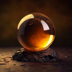 a glass ball sitting on top of a rock