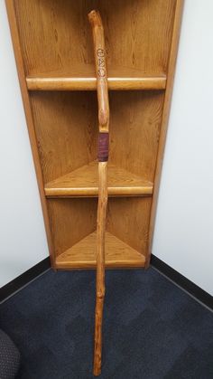 a wooden baseball bat leaning against a book shelf