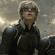 a woman in black and white is wearing goggles with her hands on her hips