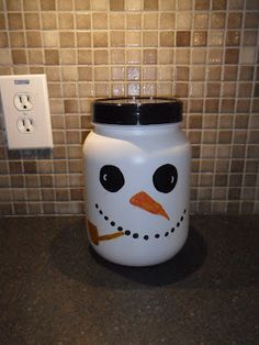 a white jar with a snowman face painted on the side and a light switch