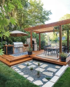 an outdoor kitchen and dining area in a backyard with stone pavers, flagstone walkways, wooden pergoline decking