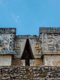 the entrance to an ancient building with stonework on it's sides and windows