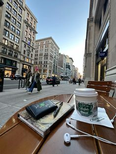 a cup of coffee sitting on top of a wooden table