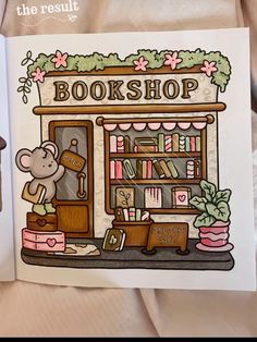 an open book with a mouse on top of it and bookshelf in the background