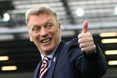 a man in a suit giving a thumbs up