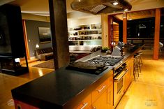 an open kitchen and living room are shown in this image, with the lights on