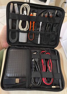 an open black case filled with electronics and cords