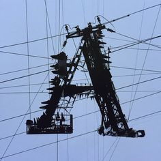 an overhead view of some power lines and wires in the sky with people on them