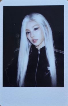 a woman with long white hair wearing a black jacket