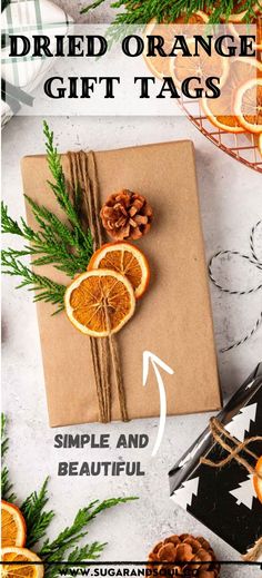 A wrapped gift with twine, pinecone, greenery and dried oranges.