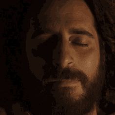 a man with his eyes closed looking down