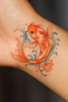 a goldfish tattoo on the wrist