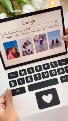 someone is holding up a laptop with pictures on the screen and candles in front of them