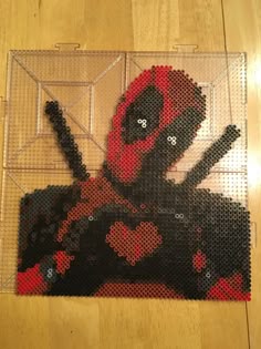 the deadpool is made out of legos and has been placed on a wooden floor