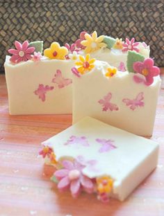 two soap bars with flowers and butterflies on them