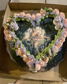 a heart shaped cake sitting inside of a box