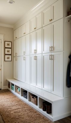 a large white closet filled with lots of cabinets