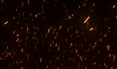 fire sparkles in the night sky on a dark background with lots of small sparks