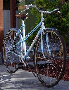 a blue bicycle is parked on the sidewalk