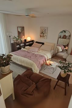 a bedroom with a bed, chair and mirror in it's centerpieces