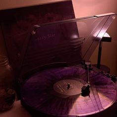 an old record player sitting on top of a table