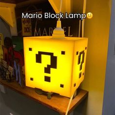 a lamp that looks like a box with a question mark on it and the words mario block lamp above it