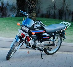 a black and blue motorcycle parked on the street