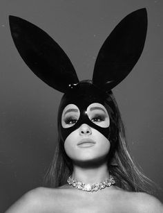 a woman wearing a bunny mask with the words dangerous woman written on her face in gold