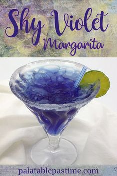 a blue margarita in a martini glass with a lime slice on the rim and text that reads, sky violet margarita