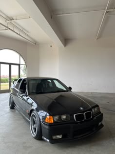 a black car parked in an empty garage
