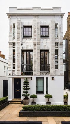 a white building with black doors and windows