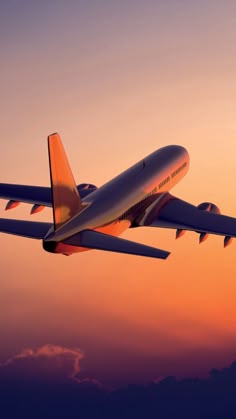 an airplane is flying in the sky at sunset