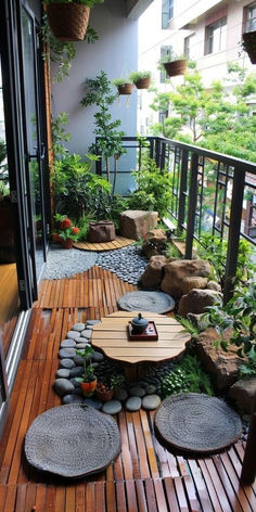 an outdoor patio with wooden flooring and plants on the side walk, surrounded by rocks